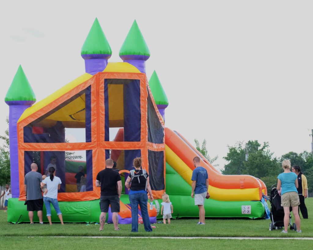 Family jumping together in a bounce house
